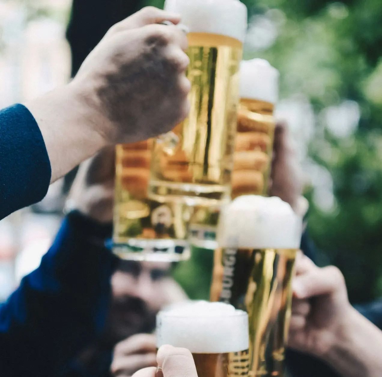 five beer mug filled with beer