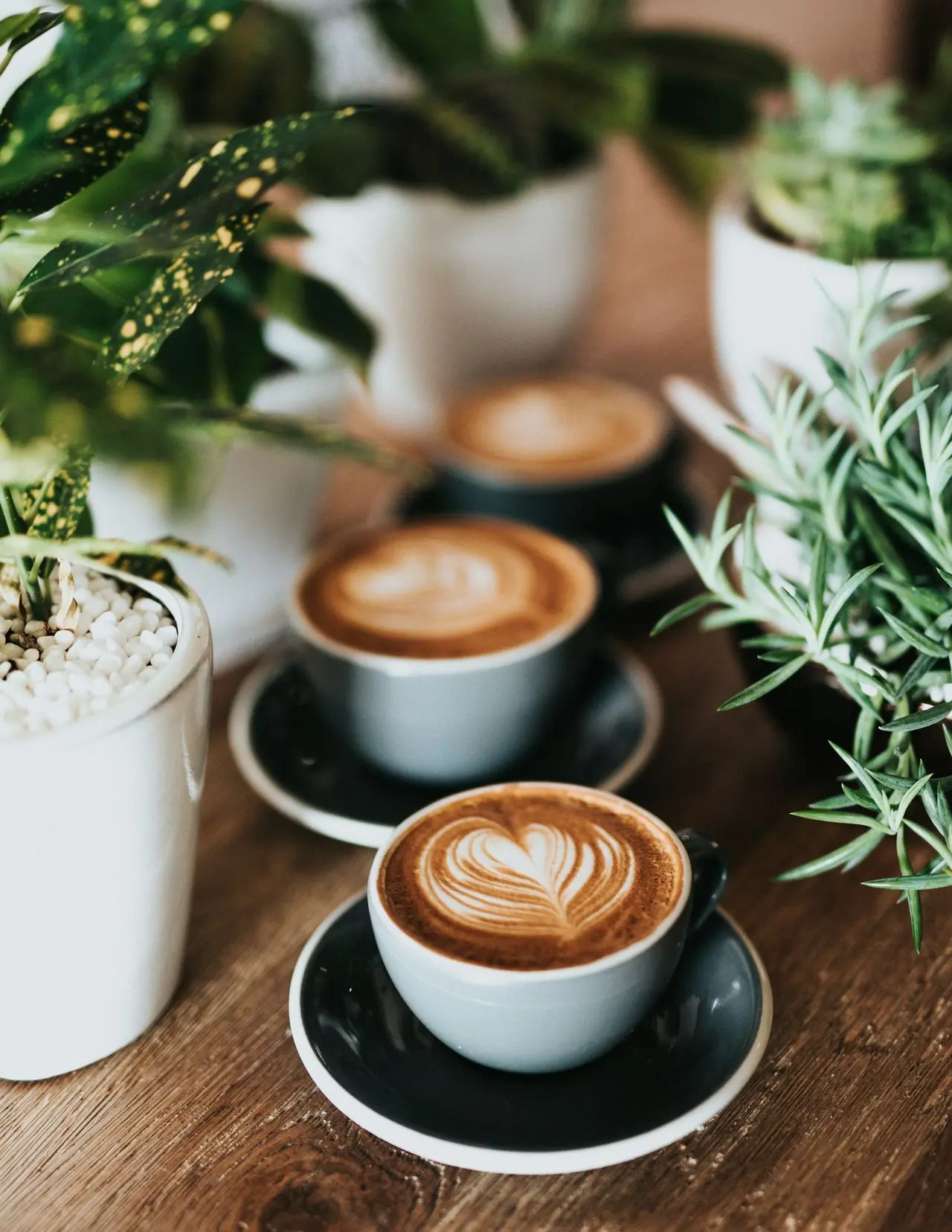 shallow focus photography of coffee late in mug on table